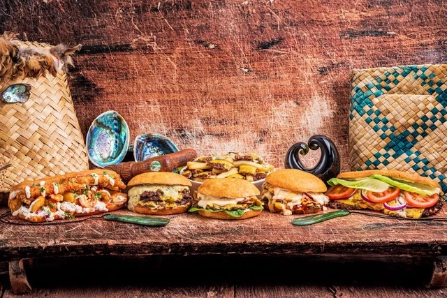 Pai Kai burgers and seafood rolls with woven kete and pāua shells
